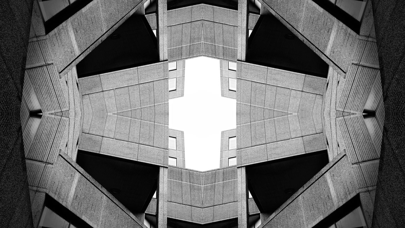 Stacked concrete architectural layers forming a repeating structural pattern, visualizing a knowledge and control layer sitting above AI engines